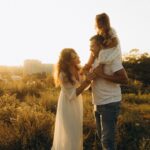 A family enjoys a beautiful sunset outdoors, capturing a moment of love and togetherness.